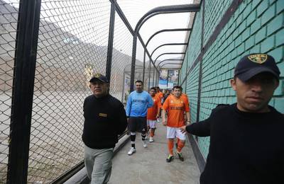 Prisoners, wearing jerseys in the colours of the Netherlands national football team, participate in the opening ceremony of their own version of the 2014 World Cup at the Castro-Castro prison in Lima on Monday. Mariana Bazo / Reuters / June 2, 2014