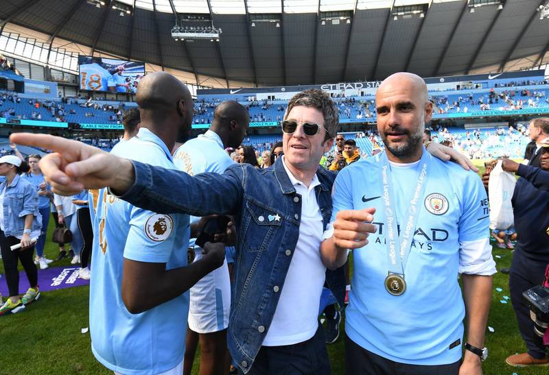 Musician Noel Gallagher speaks to Pepep Guardiola during the title celebrations. Michael Regan / Getty Images