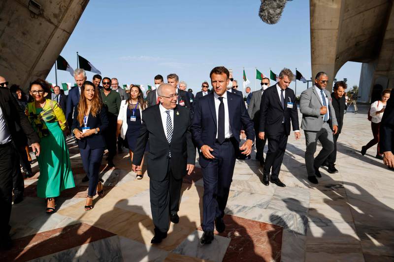 Mr Macron, accompanied by Algeria's Foreign Minister Ramtane Lamamra, on the visit to the Martyrs' Monument. AFP