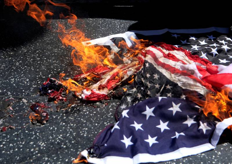 A US flag burns  at Donald Trump's star on the Hollywood Walk of Fame during an anti-Trump rally in in Los Angeles, California, US, July 4. Ringo Chiu / Reuters