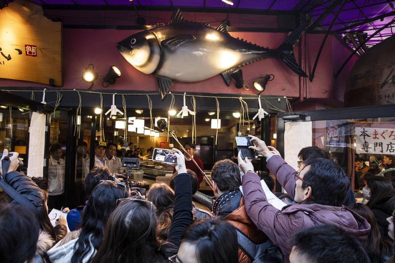 People gather outside a Sushizanmai restaurant in Tokyo, Japan.  Bloomberg