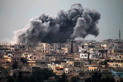 Smoke billows following reported air strikes on a rebel-held area in the southern city of Daraa, on March 16, 2017. - Daraa province, the cradle of the 2011 uprising against President Bashar al-Assad's regime, is mostly held by the rebels but pro-government forces and Islamic State are also present. (Photo by MOHAMAD ABAZEED / AFP)
