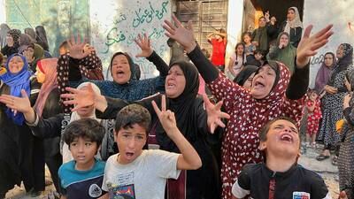 Palestinians mourn outside a house in Gaza struck by Israel. Reuters