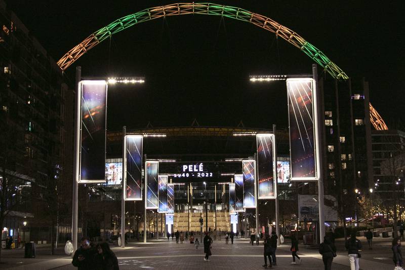Wembley Stadium's arch is lit up in the colours of Brazil to pay tribute to Pele. PA