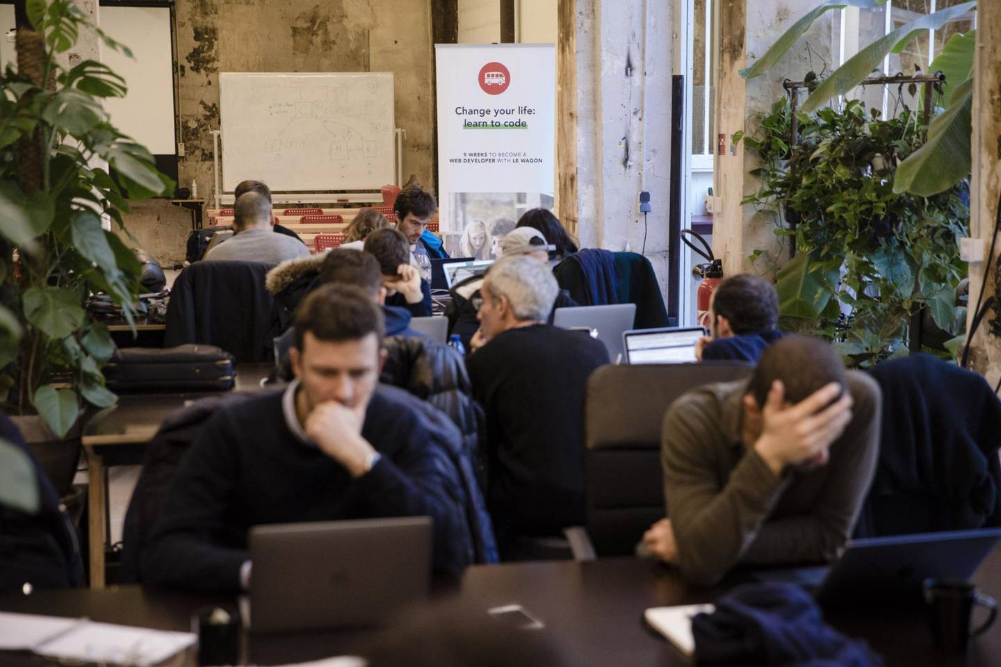 Students work at laptops at Le Wagon coding boot camp in Paris, France, on Monday, Jan. 22, 2018. Boris Paillard, who once developed equity and rates models at HSBC’s Paris office, is now co-founder of Le Wagon, a 9-week $8,000 boot camp that teaches computer code to a growing number of bankers, consultants and marketing types. Photographer: Marlene Awaad/Bloomberg