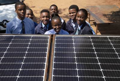 Students from the Soshanguve Automotive School of Specialisation pose behind solar panels on a train roof, north of Pretoria, South Africa last year. AP Photo
