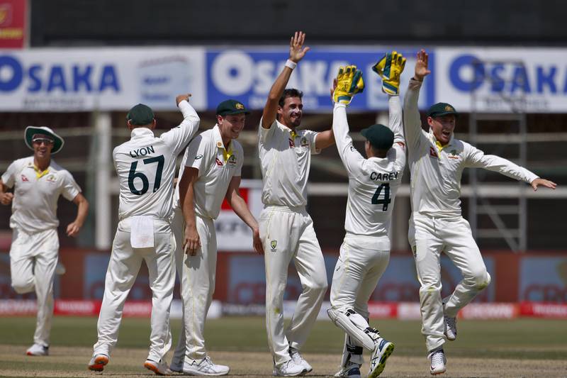 Australia's Mitchell Starc, middle, celebrates with teammates after taking the wicket of Pakistan batsman Fawad Alam for a duck. AP