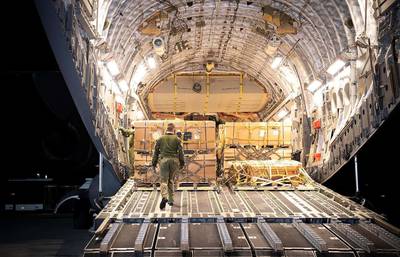 Workers unloading a Royal Canadian Air Force military transport plane to assist Ukraine at Lviv airport. AFP