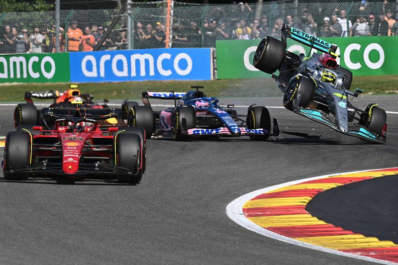 Mercedes' British driver Lewis Hamilton collides with Alpine's Spanish driver Fernando Alonso. AFP