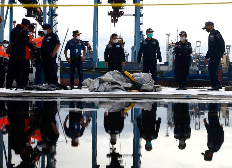 Indonesian rescue members carry what is believed to be the remains of the Sriwijaya flight SJ182 which crashed into the sea, at Jakarta International Container Terminal port in Jakarta, Indonesia. Reuters