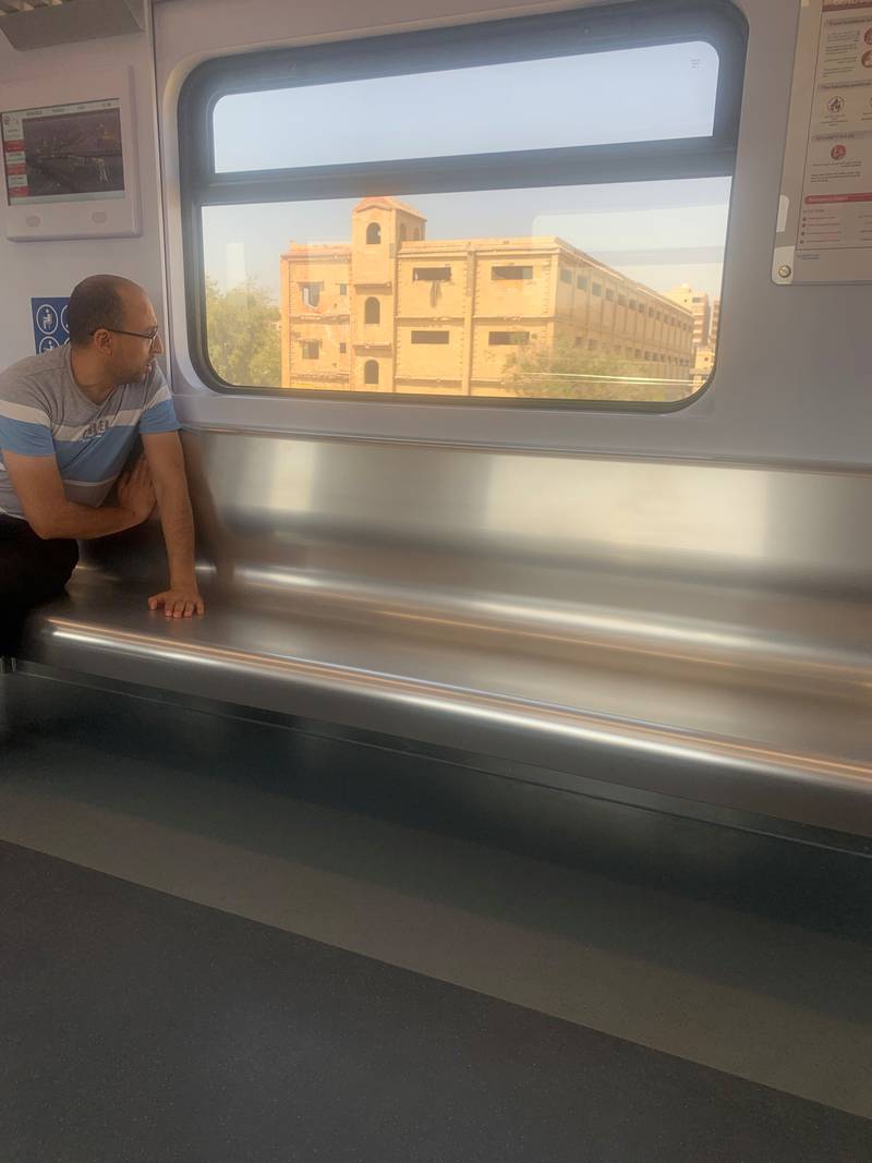 A passenger on a near-empty electric train linking new suburban communities in eastern Cairo with the Egyptian capital and the new capital farther out in the desert. Hamza Hendawi for The National