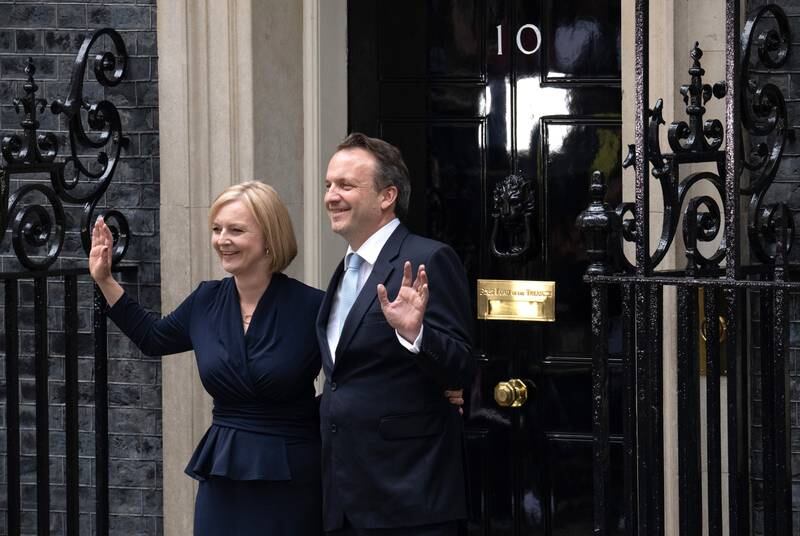 UK Prime Minister Liz Truss and husband Hugh O'Leary pose outside No. 10. Getty Images
