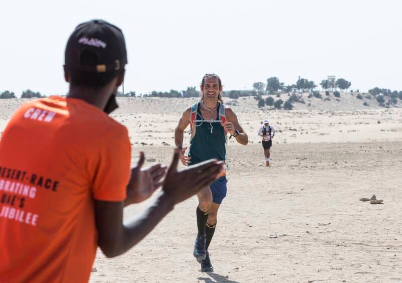 A participant reaches the finish line at Al Marmoom Ultramarathon.