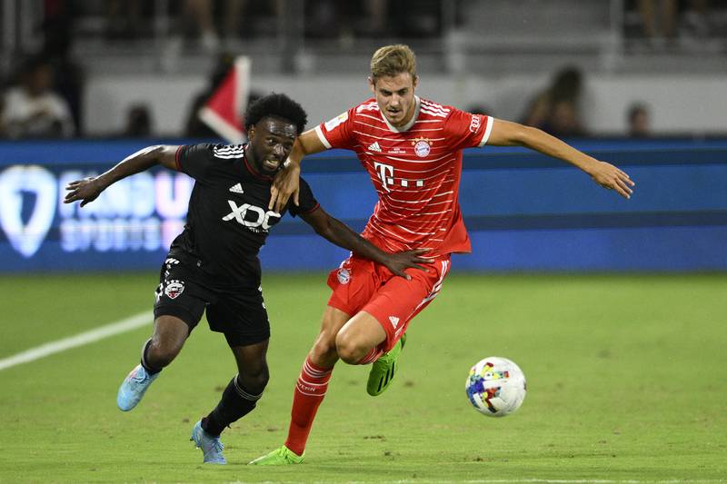 Bayern Munich defender Josip Stanisic, right, and DC  United defender Chris Odoi-Atsem vie for the ball. AP