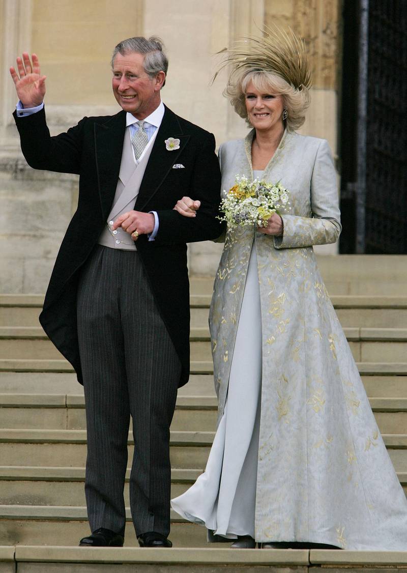 (FILES) In this file photo taken on April 09, 2005 Prince Charles waves with the Duchess of Cornwall, formerly Camilla Parker Bowles as they St George's Chapel in Windsor, England, following the church blessing of their civil wedding ceremony, 09 April 2005. Britain's Prince Charles turns 70 on November 14, 2018 as busy as ever, having spent a lifetime forging his own path during his record wait for the throne. / AFP / POOL / ALASTAIR GRANT
