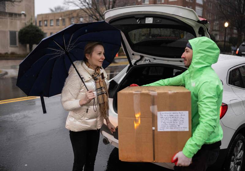 A woman drops off a box of donations at the Turkish embassy in Washington. AFP