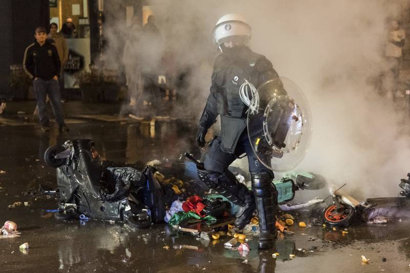 Police detained 12 people after using water cannon and firing tear gas to disperse crowds in the Belgian capital. AP