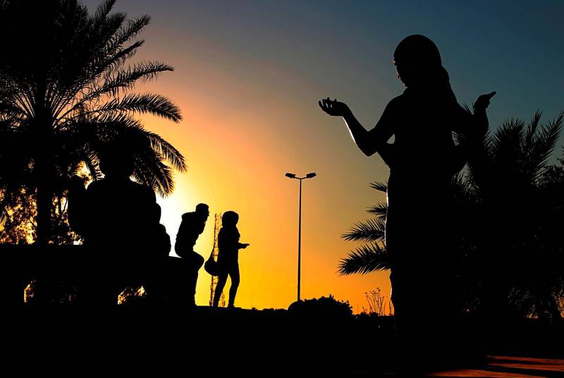 A couple walk along the banks of the Tigris near the statues of Prince Shahrazad and King Shahriar in Baghdad, Iraq. AP