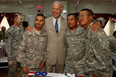 BAGHDAD, IRAQ - JULY 4:  U.S. Vice President Joe Biden (C) poses with soldiers for a photo at Camp Victory on July 4, 2009 near Baghdad, Iraq. Bidden's first visit to Iraq as the Vice President comes days after U.S. forces pulled out from Iraq's cities. (Photo by Khalid Mohammed-Pool/Getty Images)