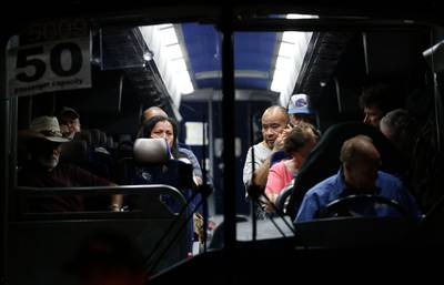 Festival attendees are whisked away from the scene on buses.  AP