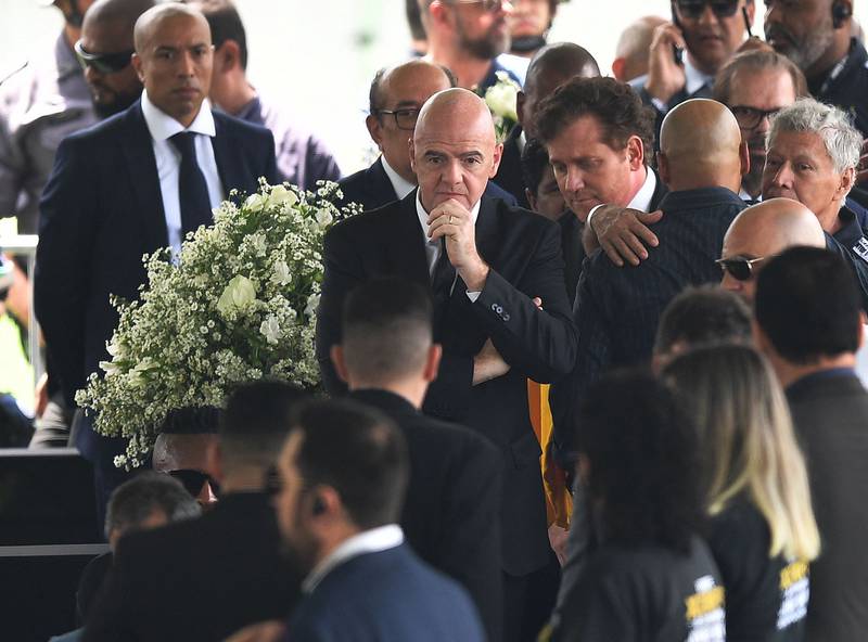 Fifa president Gianni Infantino, centre, at the wake of football great Pele in Santos. AFP