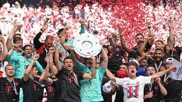 Bayern Munich's Thomas Muller and Manuel Neuer celebrate with the trophy and teammates after winning the Bundesliga title on May 27, 2023. Reuters