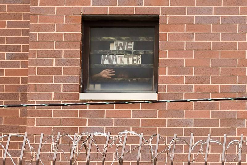 An inmate holds a sign to his cell window reading "We Matter" as Black Lives Matter supporters hold a protest against racial inequality outside Cook County Jail in Chicago, Illinois, U.S. REUTERS