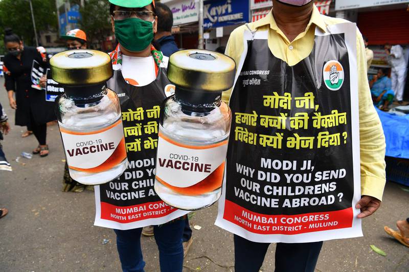 Congress Party activists hold cut-outs of Covid-19 vaccine vials during a protest against shortages in Mumbai, India. AFP