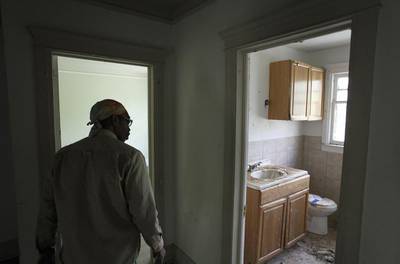A man looks at the bathroom inside one of the 13 homes in Boston-Edison that will go up for bid. Joshua Lott / Reuters