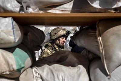 A Ukrainian serviceman guards a military check point in the city of Zhytomyr, northern Ukraine. AFP
