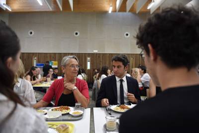 French Education and Youth Minister Gabriel Attal, right, and French Prime Minister Elisabeth Borne have lunch at the canteen of the Simone-Veil secondary school in Liffre. AFP