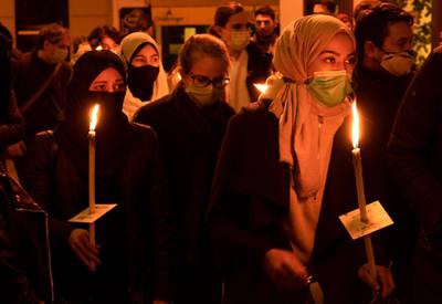 People attend a candlelight vigil remembering the victims. AFP