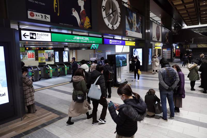 People gather at Sendai station after a strong earthquake hit northeastern Japan, in Sendai, northeastern Japan, late 13 February 2021. EPA