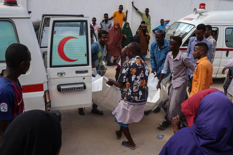 Men help to unload a victim who was injured during a car bombing attack, at the Madina Hospital. AFP
