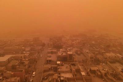 Iraq's southern city of Najaf is obscured by a dust storm on May 1, 2022. The bad weather forced the closure of the city's airport and the international airport in Baghdad. AFP