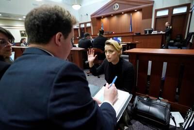 Actor Amber Heard talks to her lawyers before the hearing starts in the courtroom in April. Reuters