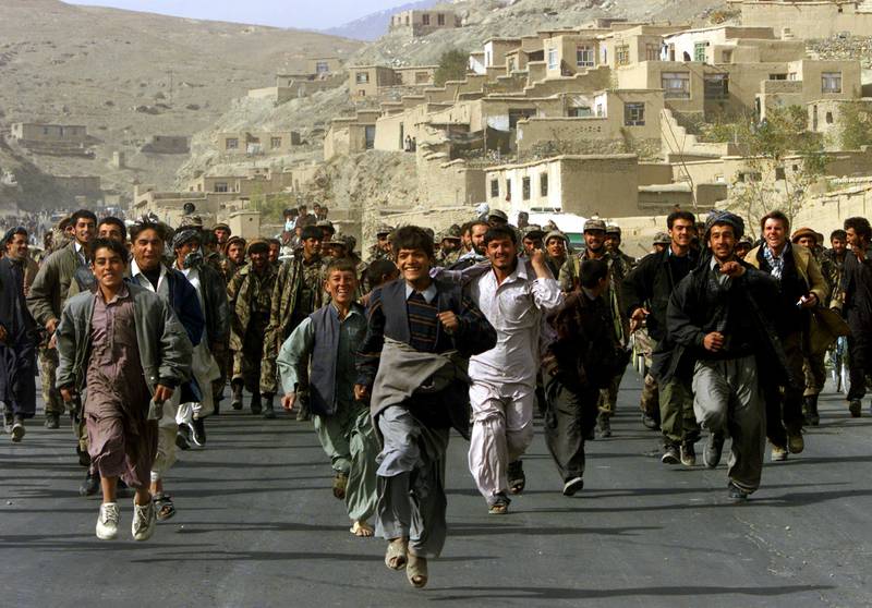 Residents of Kabul celebrate and escort Northern Alliance fighters
entering the Afghan capital Kabul in November 2001 after a collapse of Taliban rule. Reuters