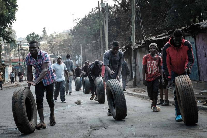 Protesters roll tyres towards a barricade in the Kibera neighbourhood of Nairobi, where supporters of Kenya’s opposition leader Raila Odinga have again clashed with police. AFP