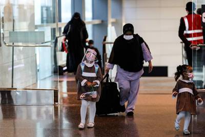 Mask-clad travellers arriving on the first Air Arabia flight landing at Qatar's Hamad International Airport walk at the terminal on January 18, 2021. AFP