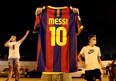 A Barcelona fan holds up a Lionel Messi shirt outside the Camp Nou after captain Lionel Messi told Barcelona he wishes to leave the club immediately, a source confirmed on Tuesday. Reuters