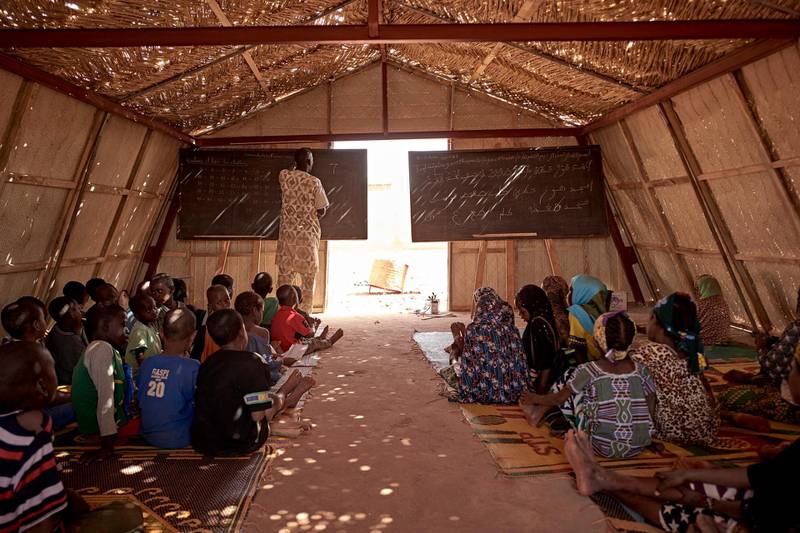Displaced children take a course in a classroom of the camp for IDPs of Sevare in central Mali on March 02, 2020. - In total 151 households and 712 Internal Displaced People fled their villages in central Mali and found a shelter in the camp CAN 2002 of Sevare. (Photo by MICHELE CATTANI / AFP)