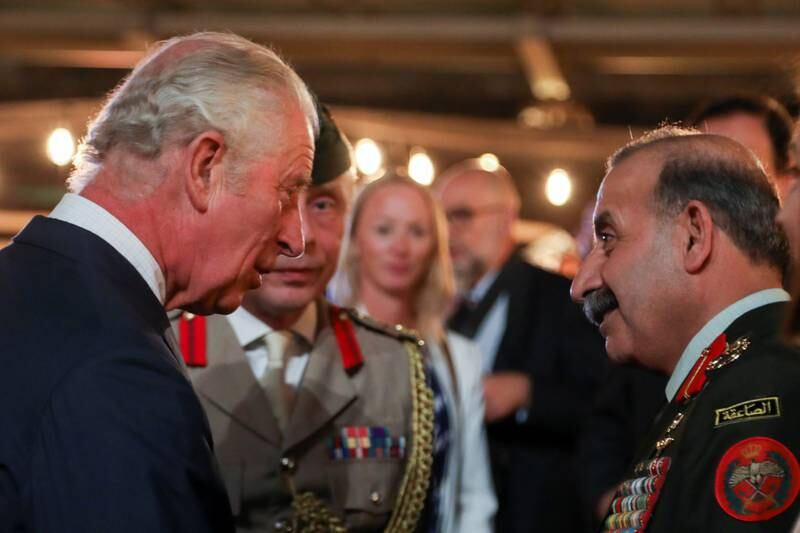 Britain's Prince Charles, Prince of Wales, talks with a Jordanian army member. Reuters