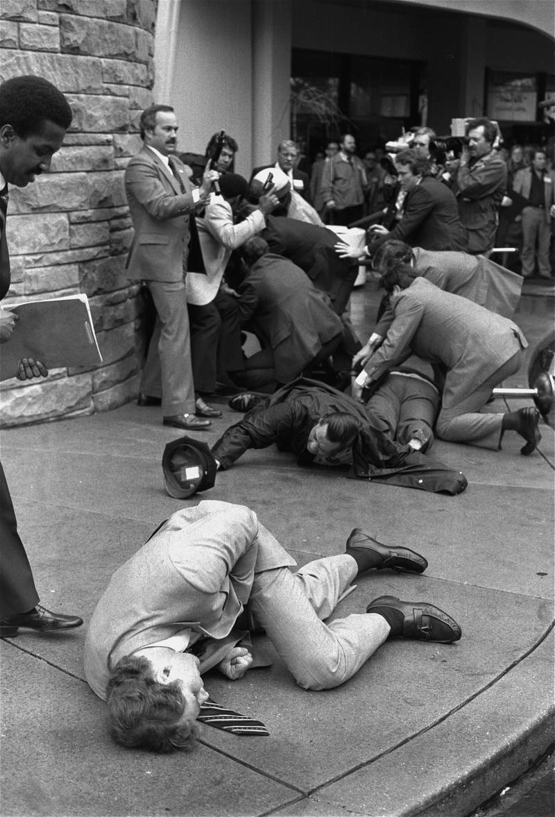 In this file photo from 1981, Secret Service agent Timothy McCarthy, foreground, Washington policeman Thomas Delehanty, centre, and presidential press secretary James Brady, background, lie wounded on a street outside a Washington hotel after shots were fired at Ronald Reagan. AP