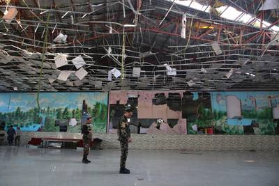 Afghan soldiers inspect a damaged Dubai City wedding hall after an explosion in Kabul, Afghanistan. AP