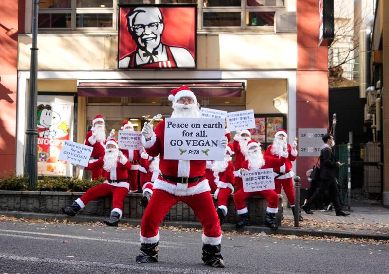 Activists from the People for the Ethical Treatment of Animals channel the Christmas spirit for a protest outside a KFC branch in Tokyo, urging to chain to offer vegan options. EPA