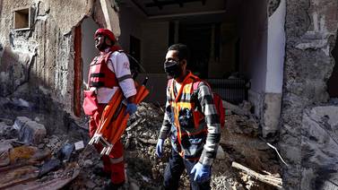 Rescuers check the damage of a house following an Israeli raid in the occupied West Bank city of Jenin on November 29, 2023.  An eight-year-old boy and a teenager were killed in Jenin by the Israeli army on November 29, according to the Palestinian health ministry.  (Photo by Zain JAAFAR  /  AFP)