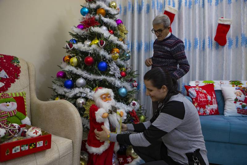 An Iraqi family decorates a Christmas tree at their house in Basra. AP
