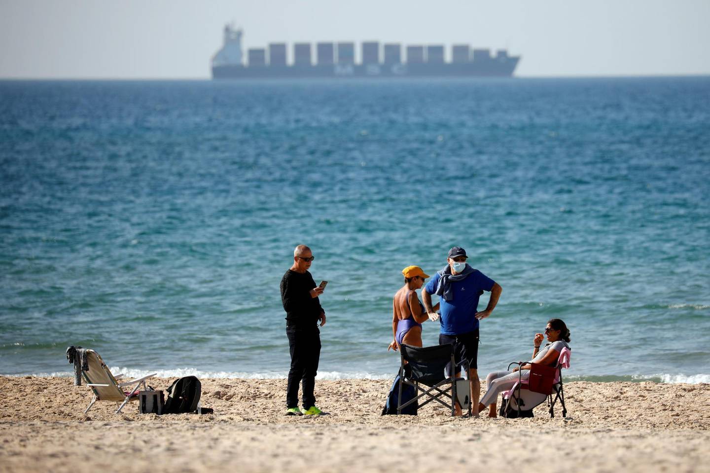 People hang out by the shore of the Mediterranean as Israel tightens a national lockdown in a bid to curb a sharp rise in new coronavirus disease (COVID-19) infections in Ashdod, Israel January 8, 2021. REUTERS/ Amir Cohen