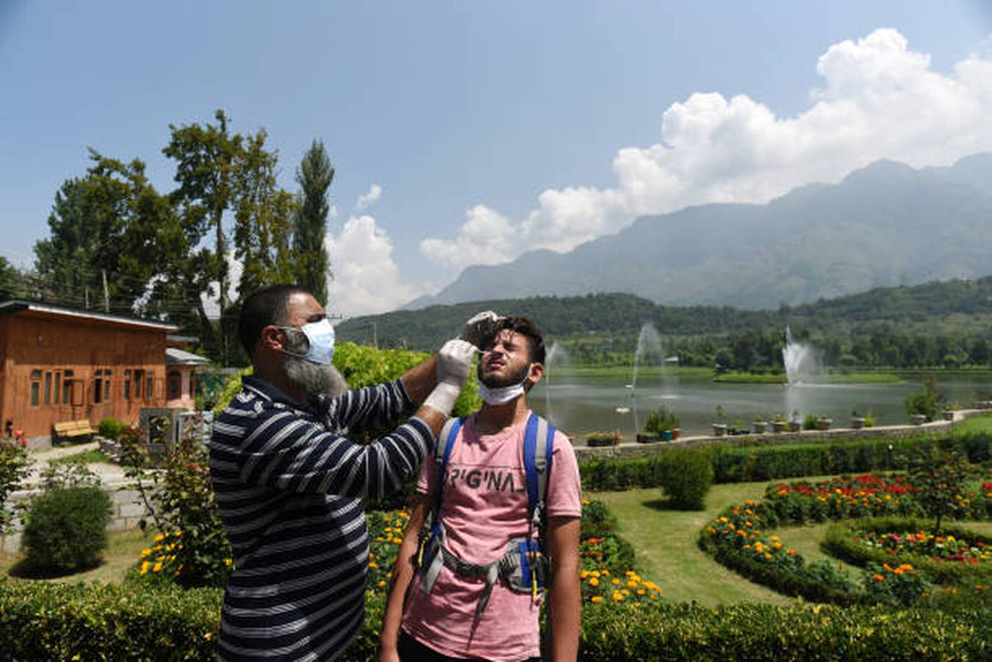 A paramedic collects a nasal swab sample for Covid-19 test in Srinagar. Getty Images