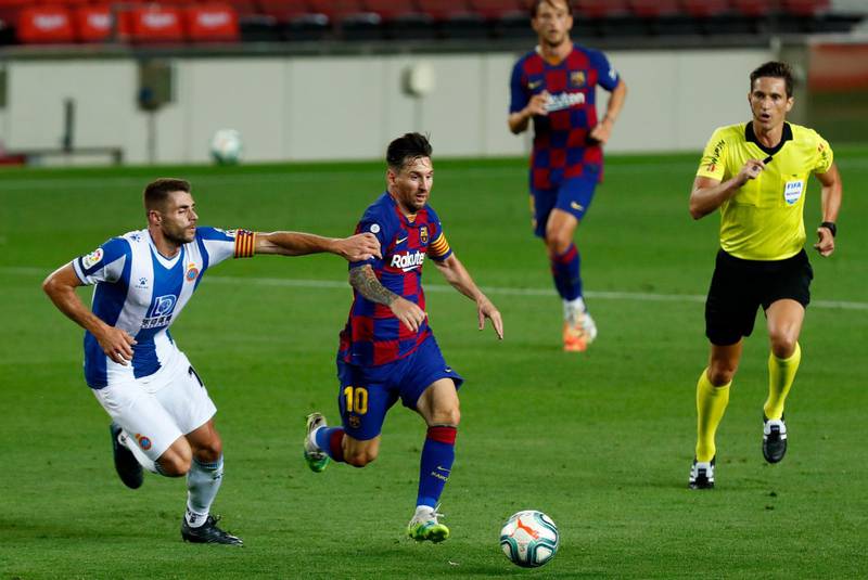 Barcelona's Lionel Messi runs for the ball next to Espanyol's David Lopez. AP Photo